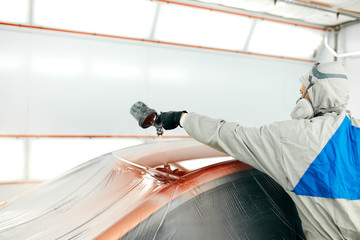 repairman painter in chamber painting automobile car roof