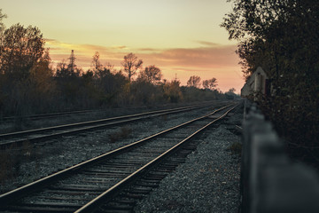 Old railway outside the city at sunset