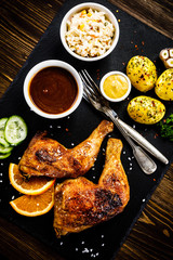Grilled chicken legs with boiled potatoes and vegetables
