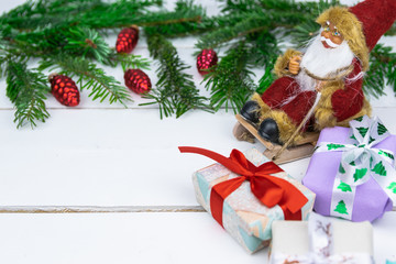 Christmas presents with a spruce twig and decorations on a white background.