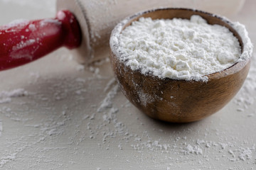 Wooden Bowl of Flour with Red Handled Rolling Pin