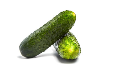 Two green fresh gherkins isolated on white background