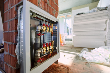 Laying pipes for floor heating at the construction site.