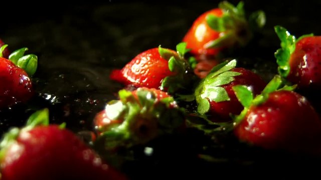 Splashing red straberry fresh fruits in water