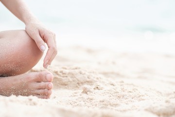 young woman sitting in relaxation outdoors on tropical beach with sand, body parts. Tanned sunbath girl in Lotus position yoga relax, and meditation. summer travel holiday concept.