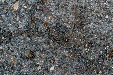 Texture of asphalt road with sand and stones and pits