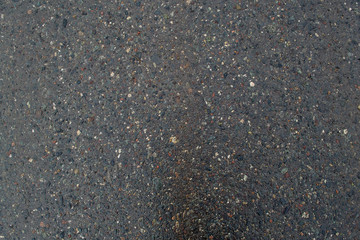 Texture of asphalt road with sand and stones and pits