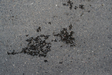 Texture of asphalt road with sand and stones and pits