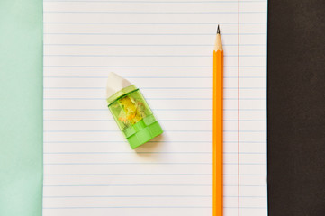 exercise book with pencil. pencil with sharpener