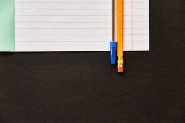exercise book with pencil.