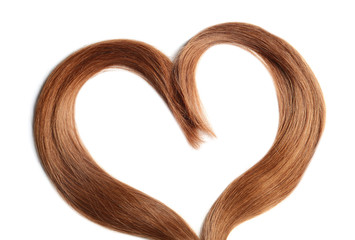 Heart made of red hair locks on white background