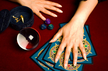 astrologer with zodiac dice, crystal ball, pendulum, tarot cards and pentagra, like magic astrology...