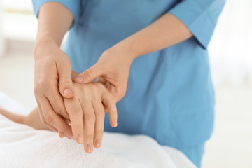 Fototapeta na wymiar Woman receiving hand massage in wellness center, closeup