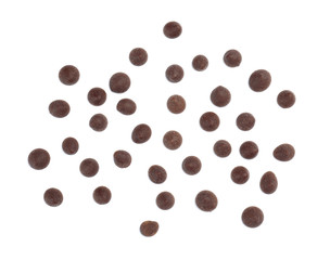 Delicious dark chocolate chips on white background, flat lay