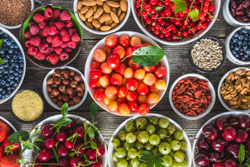 Selection of food, fresh fruits and vegetables, berries, nuts and seeds. Healthy eating concept