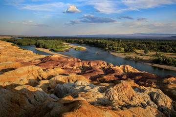 Rainbow Beach, Five Colored Hills scenic area, an oasis in the desert near Burqin. Buerjin, Altay, Xinjiang Province, China. Colorful hills and the beautiful Irtysh River. Exotic Asia Landscapes
