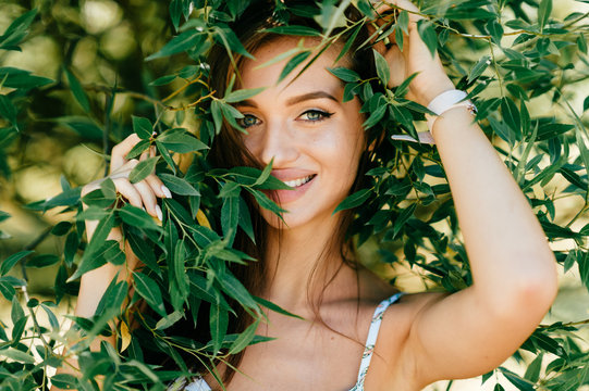 Closeup lifestyle portrait of celebrity female model.  Beautiful girl face on abstract nature background. Cheerful amazing young woman face expression. Sexy blue eyed babe. Glamour youth appearance.