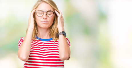 Beautiful young woman wearing glasses over isolated background with hand on head for pain in head because stress. Suffering migraine.
