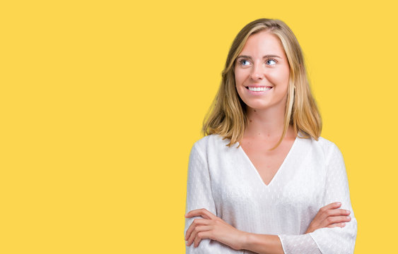 Beautiful young elegant woman over isolated background smiling looking side and staring away thinking.