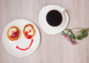 Summer cottage cheese pancakes on white plates on a table with jam, closeup, Smiling. Smile for sweet breakfast with love
