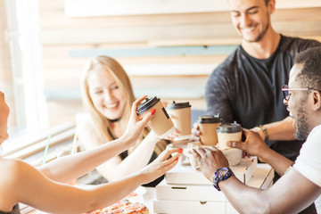 people, drinks and food concept - close up of happy multiethnic co-workers having lunch at...