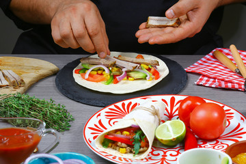 male street vendor hands in gloves make taco. Mexican cuisine snacks, fast food of commercial kitchen