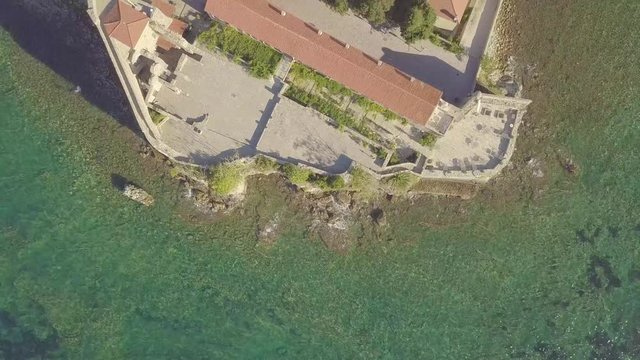 Flying above old town of Budva Montenegro towards city beach, Budva Marina and Adriatic sea with Dukley Zavala on background. Aerial footage.