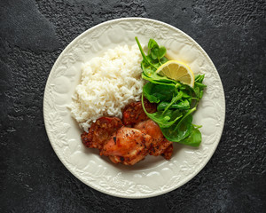 Roasted boneless skinless chicken thighs with rice and green vegetables mix