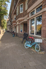 Fototapeta na wymiar parked bicycles near brick house