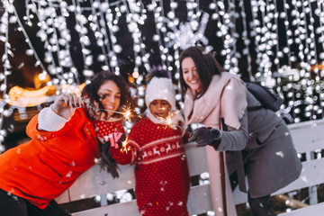 Mother with her daughter and friend enjoying in ice skating. © hedgehog94