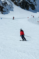 Fototapeta na wymiar Female skier in downhill slope. Winter sport recreational activity