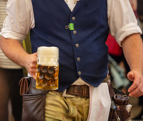 Oktoberfest, Munich, Germany. Waiter serving beer, closeup view