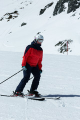 Female skier in downhill slope. Winter sport recreational activity