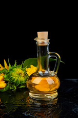 Sunflower oil in glass jar, seeds and flowers