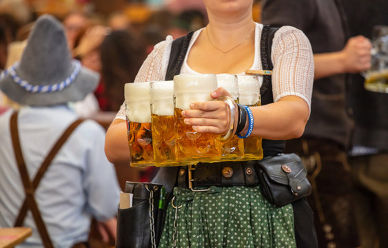 Oktoberfest, Munich, Germany. Waiter with traditional costume holding beers