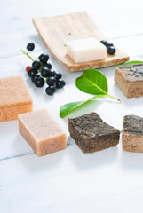 salt and milk soaps, hair colourant henna blocks on white wooden table