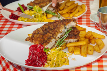 Polish dinner plate - pork chop with chips, grated beets and salad