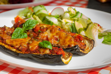 Healthy dinner plate - Zucchini stuffed vegetables and salad - letuce with cherry tomatoes, radish and cucumber