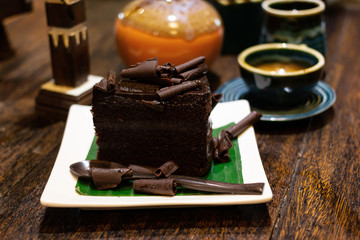 Chocolate Cake and Tea and coffee In a ceramic cup on table wood
