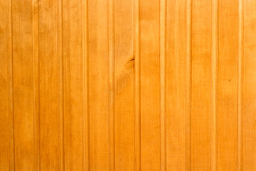 The wooden wall of yellow color is made of profile strip