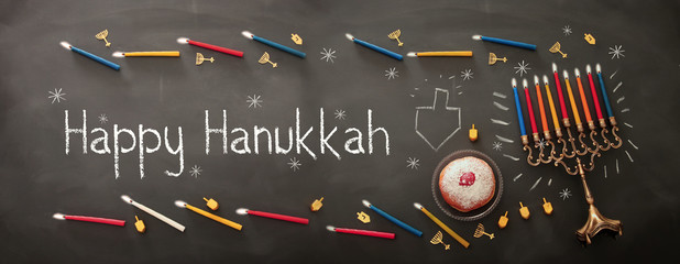 Banner of jewish holiday Hanukkah background with traditional spinnig top, menorah (traditional candelabra) and burning candles.