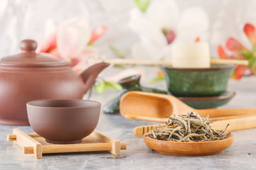 brown ceramic teapot with cups on special wooden coasters is prepared for a traditional Asian tea ceremony