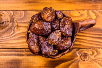 Date fruits on a wooden table. Top view