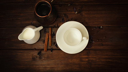 cup, milk and turk fresh coffee with cinnamon on a dark wooden table background