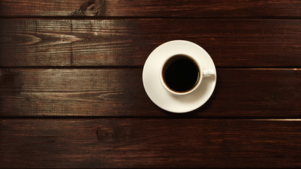 Cup of coffee on wooden table top view