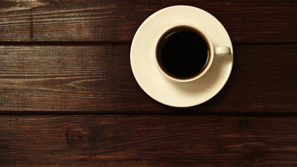 Cup of coffee on wooden table top view