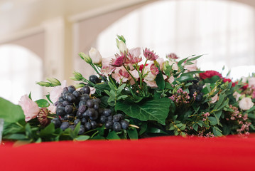 Composition from fresh flowers on a wedding table.