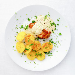 fried potato and chicken breast under sour cream mustard sauce sprinkled with parsley