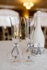 Glasses of the groom and bride on a wedding table