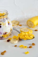 Breakfast in a jar: cereal, banana, berries, granola. The concept of healthy eating, high-carbon Breakfast.